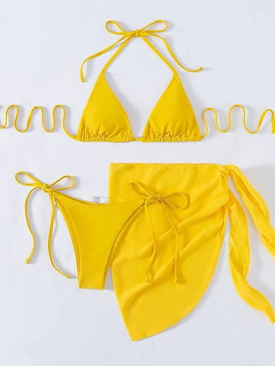 Neon yellow three-piece bikini set with triangle cup lace-up top, tie-side bottom, and matching sarong, displayed with a straw hat and sunglasses. - Image 9
