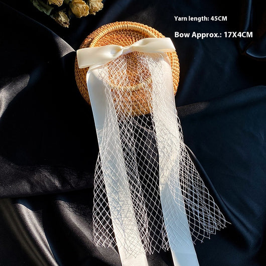 White birdcage veil with a cream satin bow and faux pearls, attached to a woven straw base, 80cm yarn length. - Image 16
