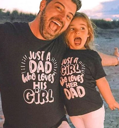 Black cotton t-shirt for dad with pink "JUST A DAD who loves HIS GIRL" text and matching baby onesie. - Image 4