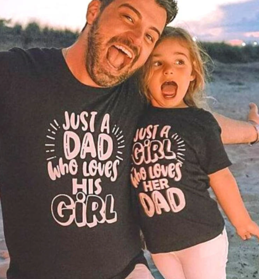 Black cotton t-shirt for dad with pink "JUST A DAD who loves HIS GIRL" text and matching baby onesie. - Image 4