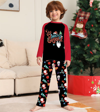 Man wearing a black and red long-sleeve Christmas pajama set with "Merry Christmas" graphic and Santa print pants. - Image 2