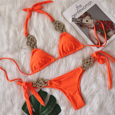 White two-piece bikini with gold braided knot details on the halter straps and tie-side bottom, laid flat. - Image 8