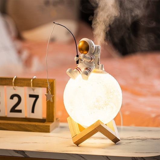 Astronaut figurine sitting on a glowing moon lamp, holding a fishing rod with a star charm, on a wooden stand. - Image 8