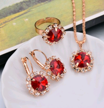 Rose gold-toned necklace, earrings, and ring set with large oval clear gemstones surrounded by smaller stones. - Image 24