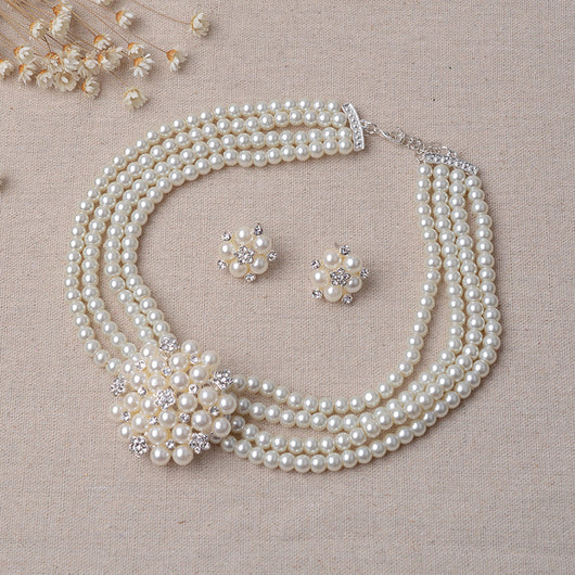 Luxury bridal pearl necklace and earring set with a multi-strand design and rhinestone flower accent. - Image 3