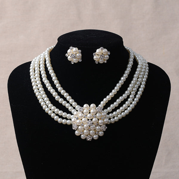 Luxury bridal pearl necklace and earring set with a multi-strand design and rhinestone flower accent.