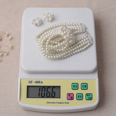 Luxury bridal pearl necklace and earring set with a multi-strand design and rhinestone flower accent. - Image 5