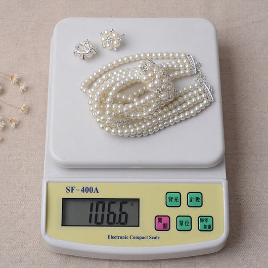 Luxury bridal pearl necklace and earring set with a multi-strand design and rhinestone flower accent. - Image 5