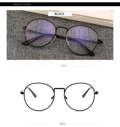 Black round anti-blue light glasses with clear lenses showing a blue reflection, resting on a gray textured surface. - Image 9