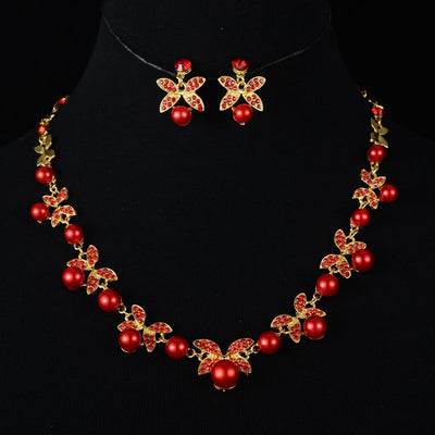 Red pearl and rhinestone necklace and earrings set with gold-toned clover designs, perfect for a wedding or special occasion. - Image 3