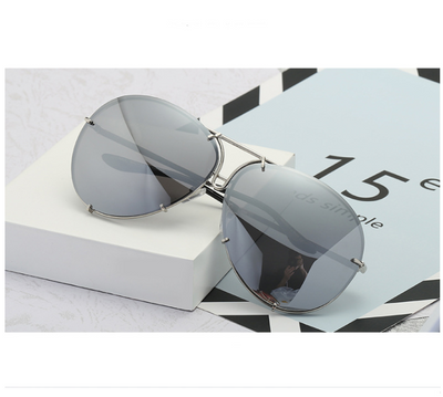 Aviator sunglasses with light blue lenses and a gold-colored metal frame, featuring a double bridge design. - Image 4
