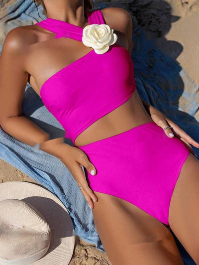 Light purple one-shoulder swimsuit with a 3D white flower detail, worn by a person lounging on a beach. - Image 5