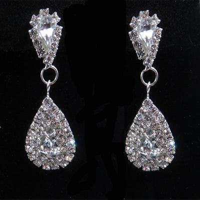 Sparkling silver-tone bridal jewelry set with a rhinestone necklace and matching teardrop drop earrings on a black bust. - Image 4