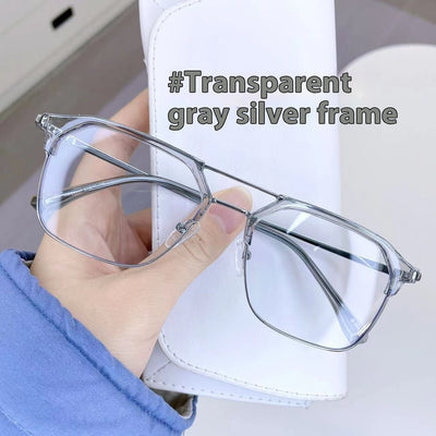 Anti-blue light glasses with a sand black and silver double beam frame, held against a white case. - Image 14