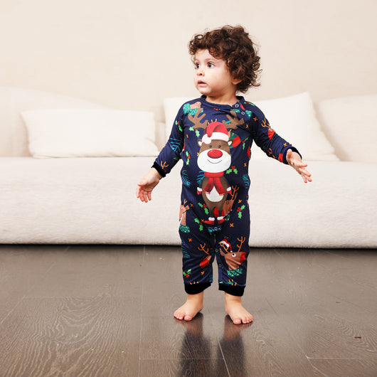 Family Christmas pajamas with a cartoon reindeer wearing a Santa hat and red scarf on a black top, and dark blue pants with a repeating reindeer and holly patte - Image 20