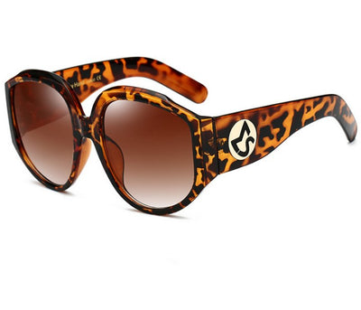 Oversize round sunglasses for women with olive frames, dark gradient lenses, and a gold emblem on the temples. - Image 10