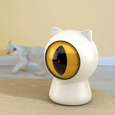 White cat-shaped laser toy with gold eye and red light, alongside a light blue smart rolling ball cat toy. - Image 3
