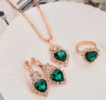 Rose gold-toned necklace, earrings, and ring set with large oval clear gemstones surrounded by smaller stones. - Image 13
