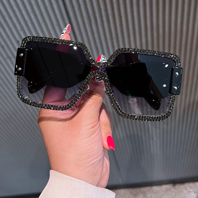 Oversized rectangular sunglasses with black lenses and frames heavily embellished with multiple rows of sparkling rhinestones. - Image 9
