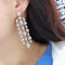 Aretes Largos de Cobre con Circonita Geométrica y Borla para Mujer