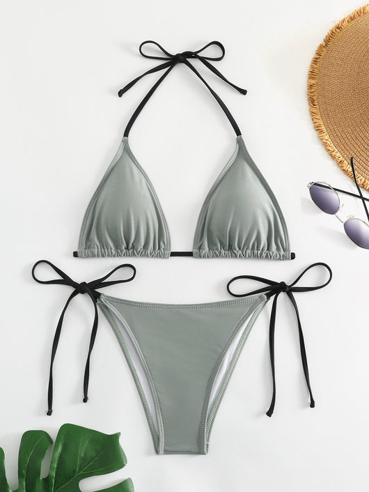 Neon yellow halter bikini with triangle top and tie-side bottoms, displayed on a light wood surface. - Image 30