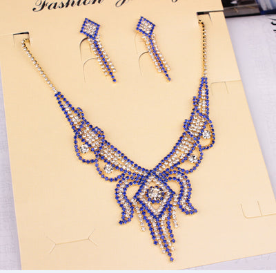 Gold-toned exaggerated butterfly necklace and matching drop earrings set, adorned with clear and champagne rhinestones. - Image 11