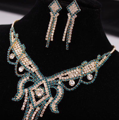 Gold-toned exaggerated butterfly necklace and matching drop earrings set, adorned with clear and champagne rhinestones. - Image 5