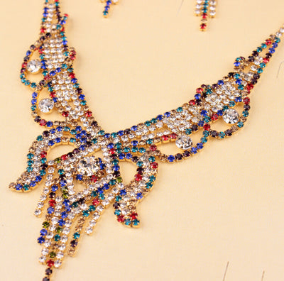 Gold-toned exaggerated butterfly necklace and matching drop earrings set, adorned with clear and champagne rhinestones. - Image 8