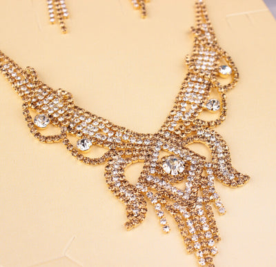 Gold-toned exaggerated butterfly necklace and matching drop earrings set, adorned with clear and champagne rhinestones. - Image 7