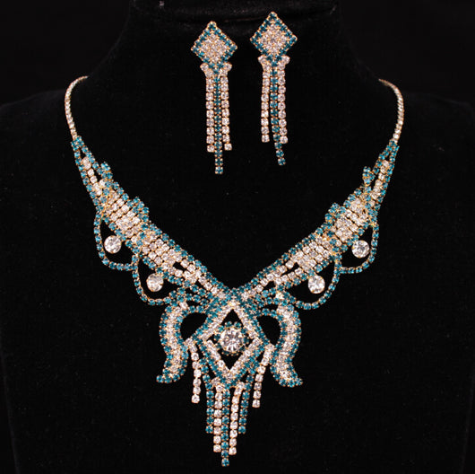 Gold-toned exaggerated butterfly necklace and matching drop earrings set, adorned with clear and champagne rhinestones.