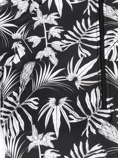 Women's black and white tropical leaf print short sleeve rash guard top with a quarter-zip, paired with solid black swim shorts featuring matching printed cuffs - Image 14