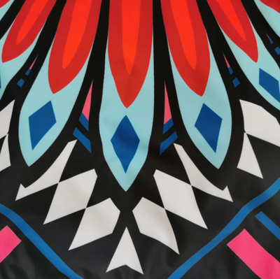 Women's long-sleeve crop top and high-waisted bikini set with a vibrant red, blue, black, and white feather-like geometric pattern. - Image 12