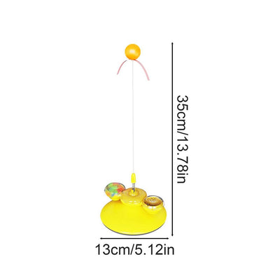 Tabby cat playing with a yellow suction cup cat toy featuring a spring-mounted teaser wand with an orange fur ball. - Image 6