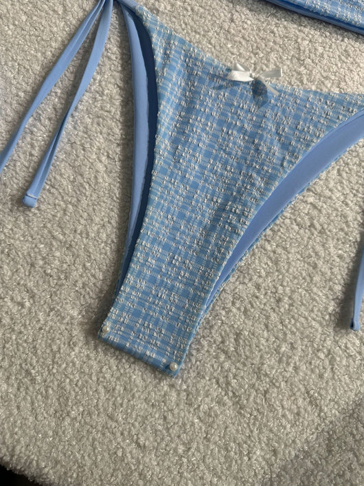 Light blue textured plaid two-piece swimsuit with a halter top and side-tie bikini bottoms, featuring small white bows. - Image 5