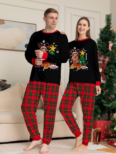 Two children in black and red plaid Christmas pajamas with a reindeer and Christmas tree graphic, standing by a Christmas tree. - Image 8