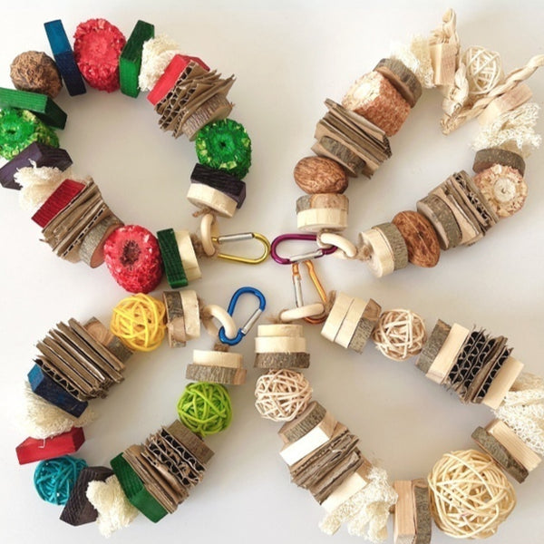 Natural wooden and rattan hanging pet chew toy with cardboard and loofah pieces for parrots, hamsters, or rabbits.