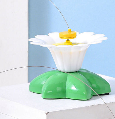 Automatic cat teaser toy with an electric rotating bird on a steel wire, attached to a green and white flower base. - Image 11