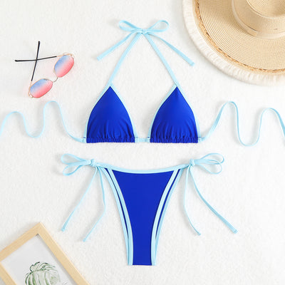 Royal blue two-piece bikini with light blue trim and tie straps, laid flat on a white textured surface. - Image 7