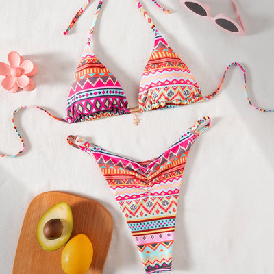 Vibrant geometric print triangle-bra bikini swimsuit with adjustable ties and high-cut ruched bottom.