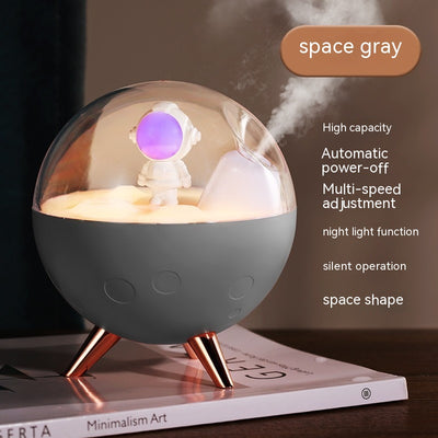 Space gray spaceman humidifier with a clear dome, glowing purple astronaut figurine, and warm yellow night light. - Image 5