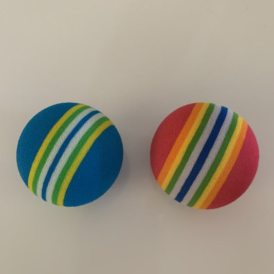 Set of three red pet play balls with rainbow stripes in varying sizes, made from soft EVA material.