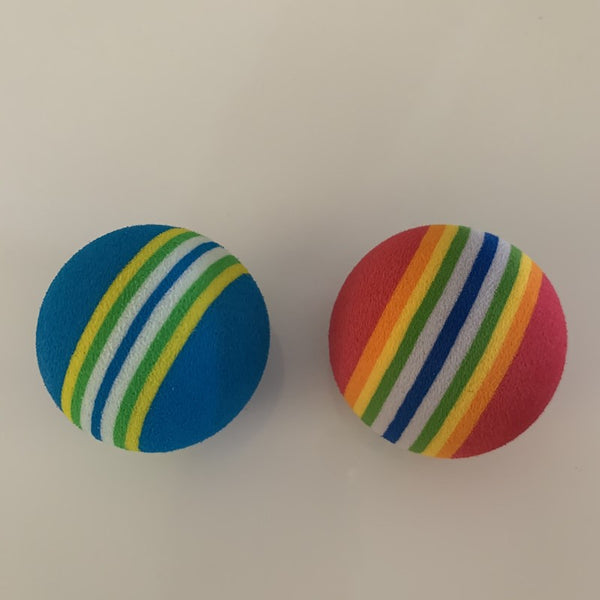 Set of three red pet play balls with rainbow stripes in varying sizes, made from soft EVA material.