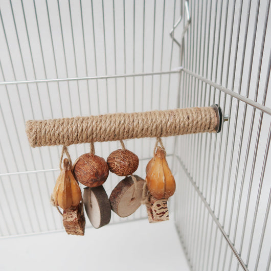 Hemp rope braided bird perch with natural wood slices and seed pods hanging, attached inside a wire bird cage. - Image 2