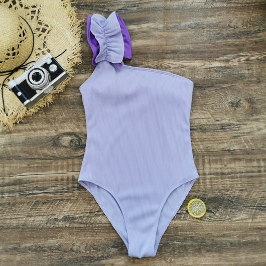 Black one-shoulder ribbed one-piece swimsuit with a ruffled blue and black strap, ideal for women's swimwear. - Image 21