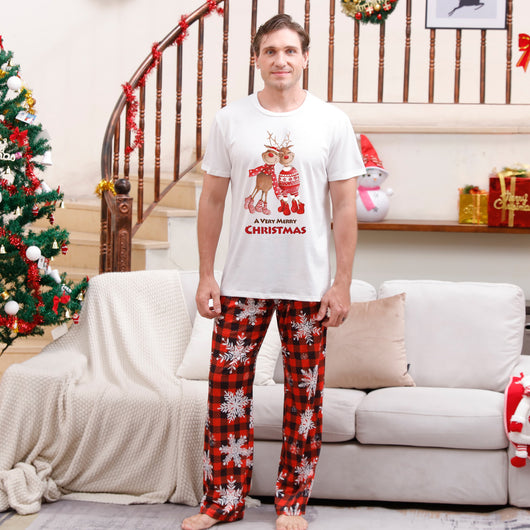 Family of five wearing matching Christmas pajamas with white 'Cousin Crew' tops and red plaid snowflake pants. - Image 8