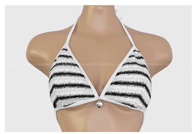 White and black striped bikini with triangle-cut top and tie-side bottom, modeled outdoors. - Image 19