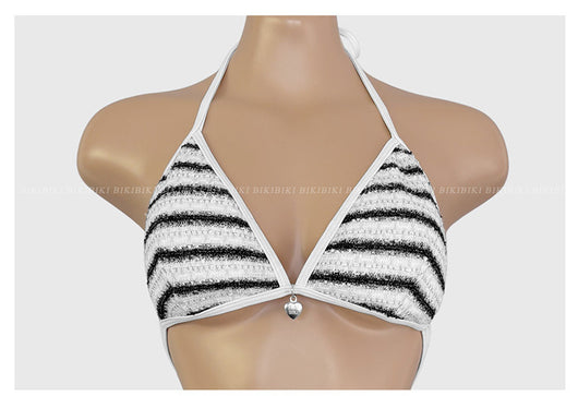 White and black striped bikini with triangle-cut top and tie-side bottom, modeled outdoors. - Image 19