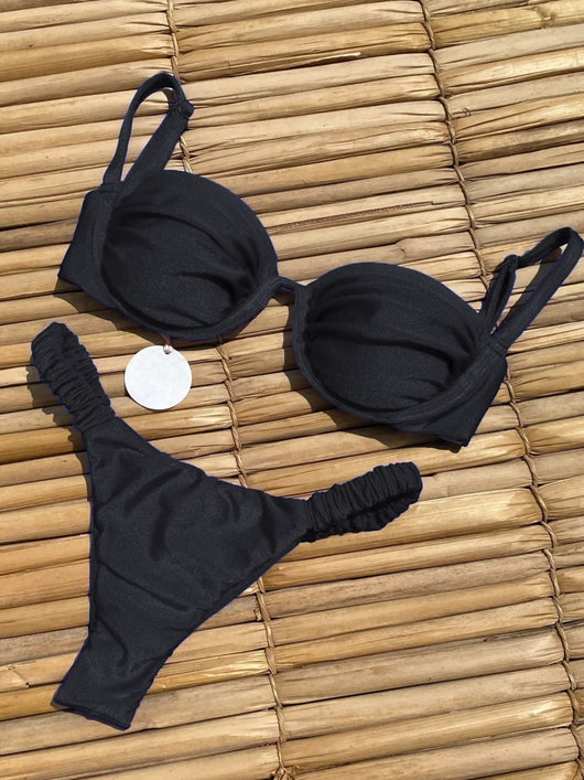 Rust underwire bikini set with ruched top and high-cut bottom, displayed on a woven mat. - Image 13
