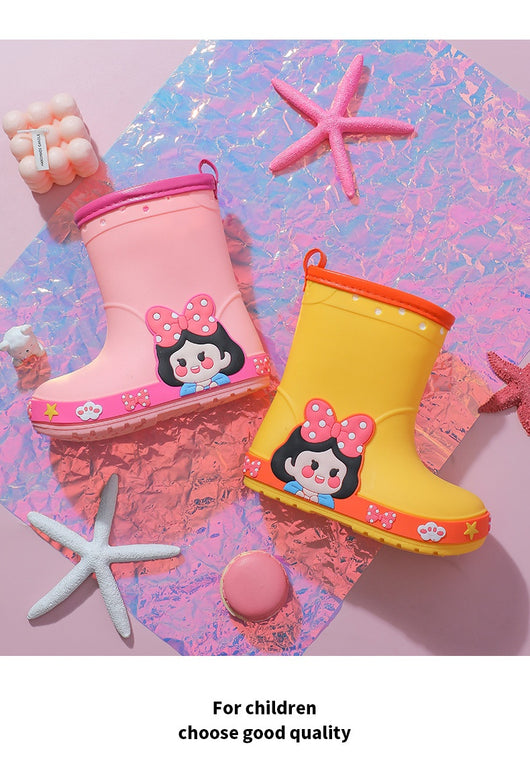 Bright yellow children's rain boots with a green cartoon dinosaur design and orange trim, held by hands. - Image 14