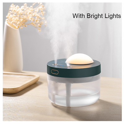 White portable projection humidifier with a translucent water tank and gold-accented control buttons. - Image 4